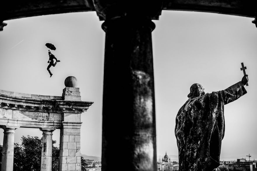 I Captured A Mysterious Umbrella Man Balancing On Budapest’s Famous Sights
