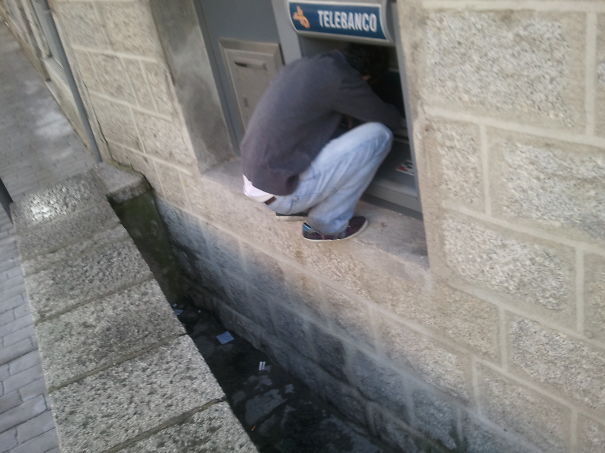 Man Withdrawing Money From Atm In Spain