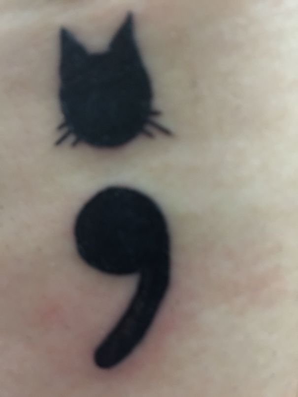 Small semicolon black cat tattoo