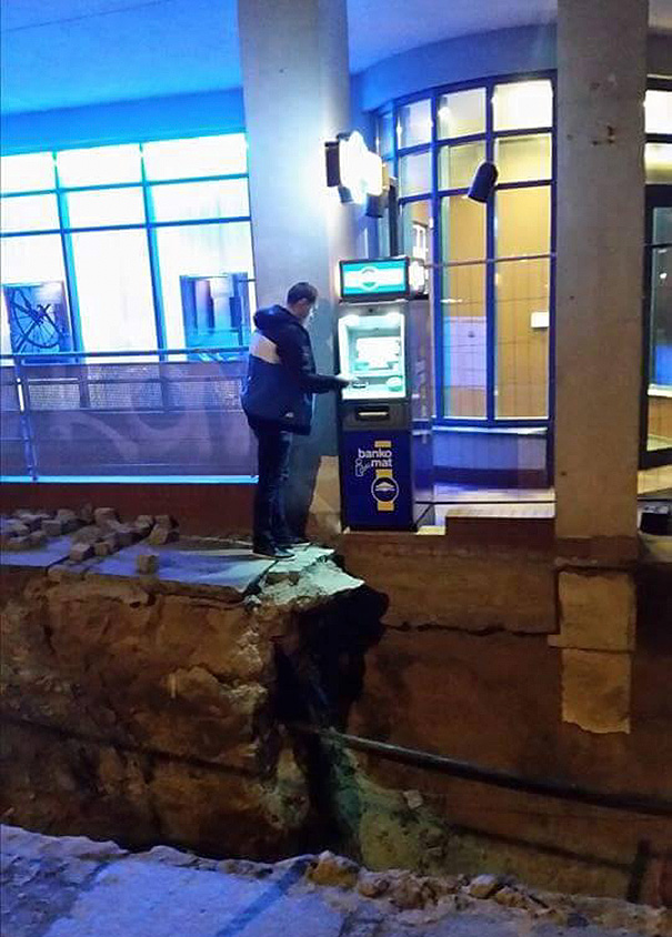 Man Withdrawing Cash From Atm In Poland