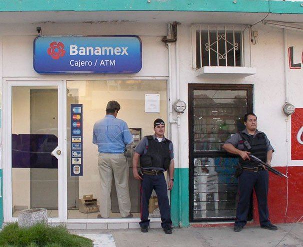Man Withdrawing Cash From Atm In Mexico