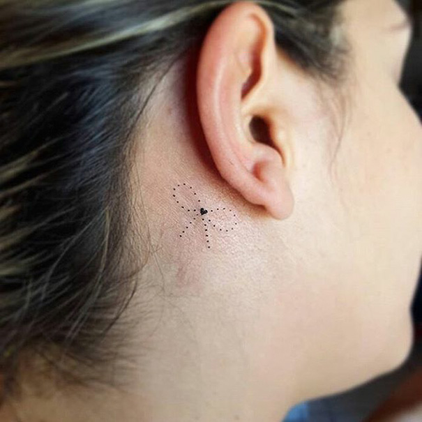 Delicate ribbon with heart tattoo behind ear