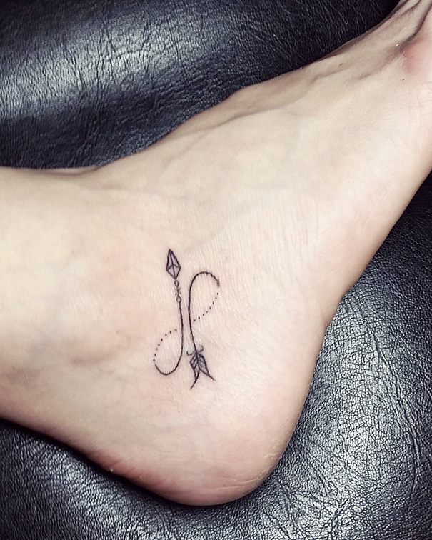 Minimal infinity arrow tattoo on foot