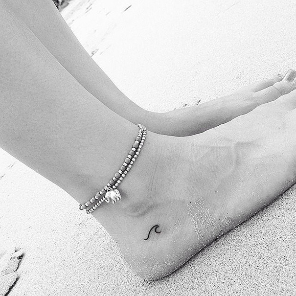 Tiny wave tattoo on foot