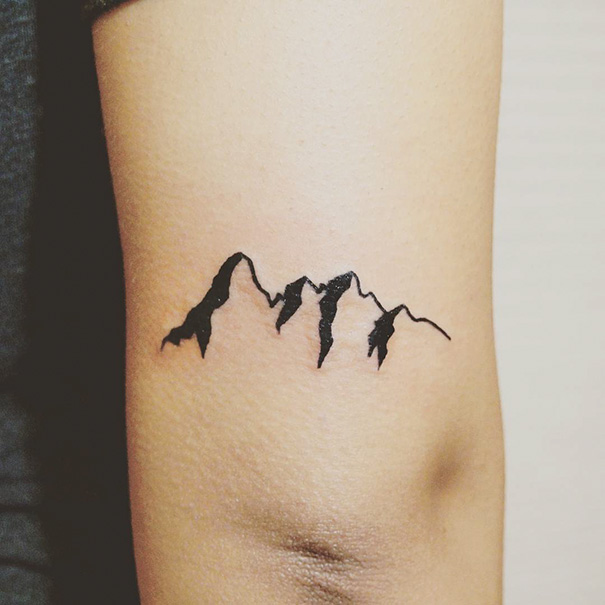 Minimal mountain tattoo on arm