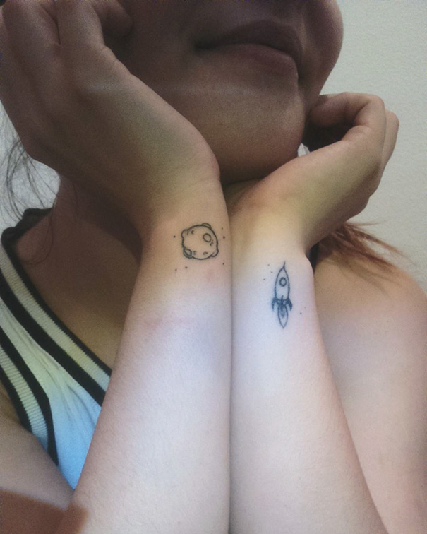 Planet on one hand and rocket on other hand simple tattoos