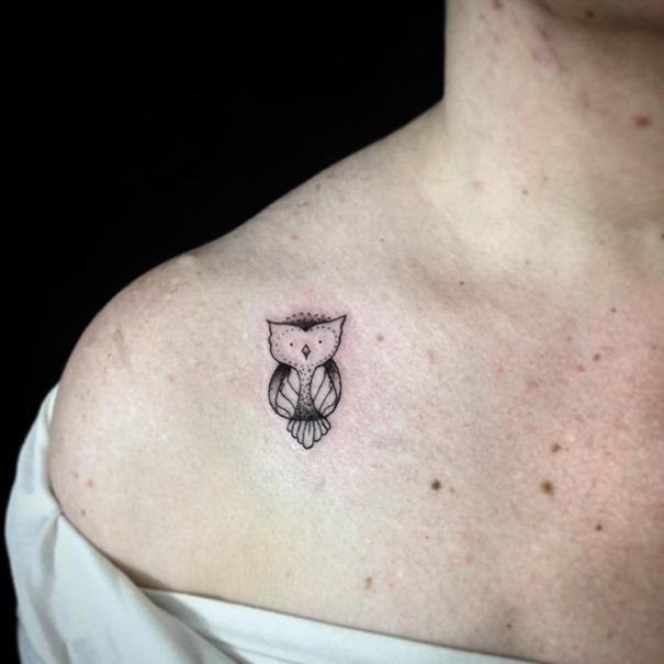 Small owl tattoo near the collarbone