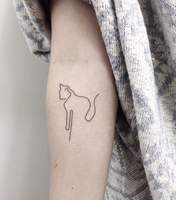 Linear cat forearm tattoo