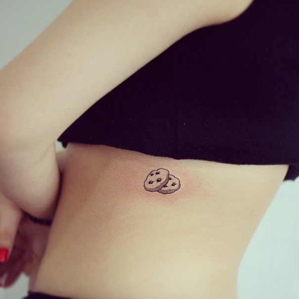 Two cookie tattoo with chocolate chips on side of the waist