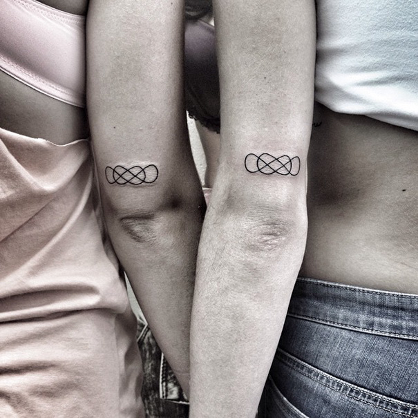 Two persons with double infinity tattoos on their arms
