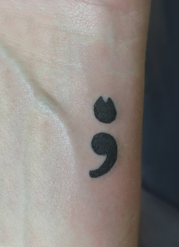 Black minimal semicolon cat tattoo