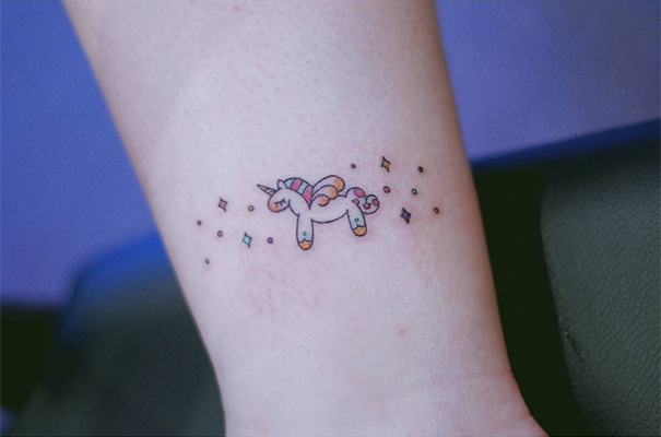 Small unicorn tattoo on hand