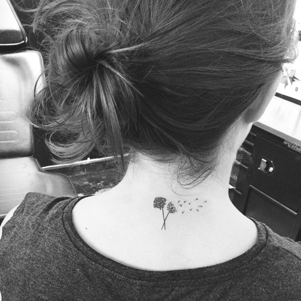 Two minimal dandelion flowers tattooed on the back neck