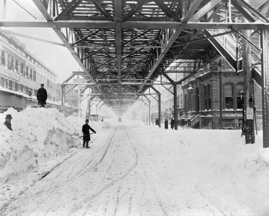 Workers Dig Out The Snow From Underneath An Elevated Train Line After The Blizzard