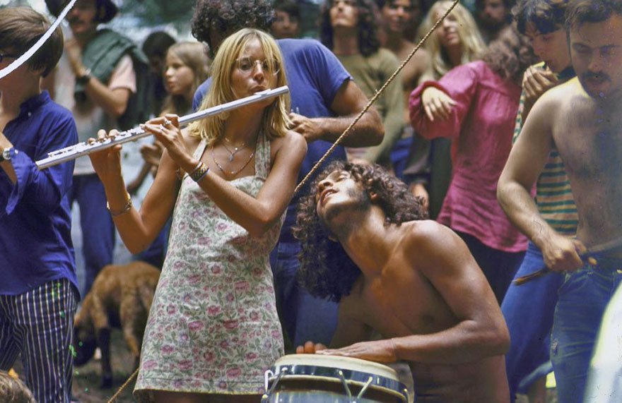 Shirtless Male Drummer & Dress-Wearing Female Flutist Jamming During Woodstock Music Festival