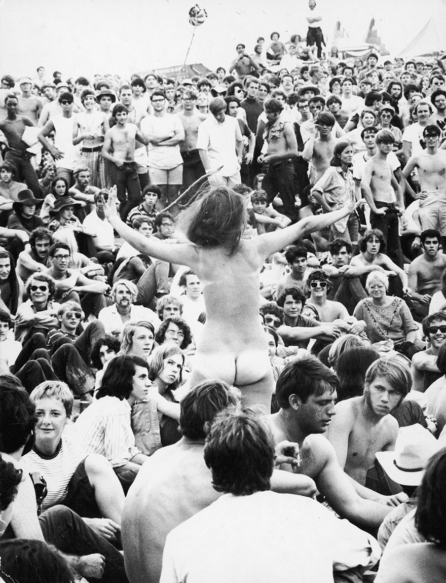 A Naked Young Woman Stands Up Amidst The Crowd During The Woodstock Festival