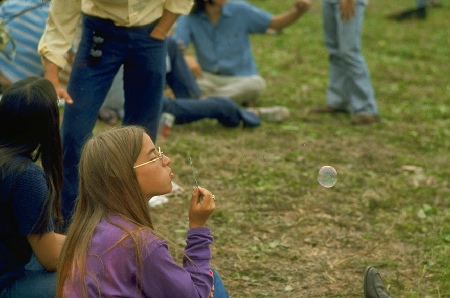 Jackie Barg Siting On The Ground & Blowing Bubbles, During The Woodstock Music & Art Fair