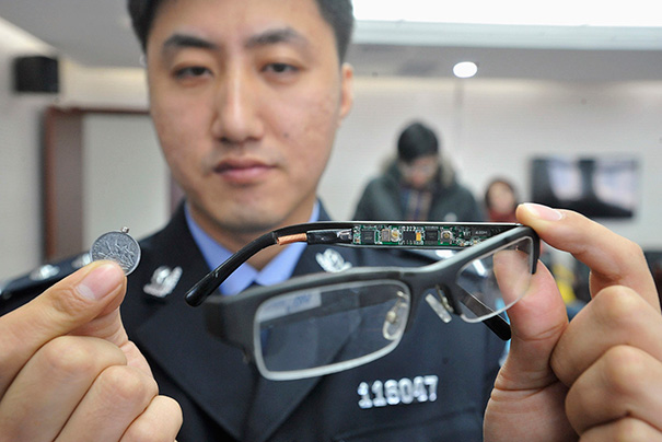 A Pair Of Glasses With A Hidden Camera And A Tiny Receiver Attached To A Coin