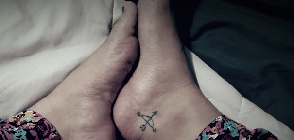 Bow with arrow ankle tattoo