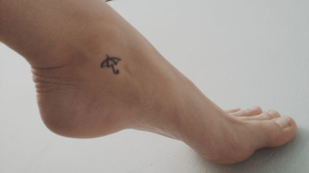 Tiny umbrella ankle tattoo