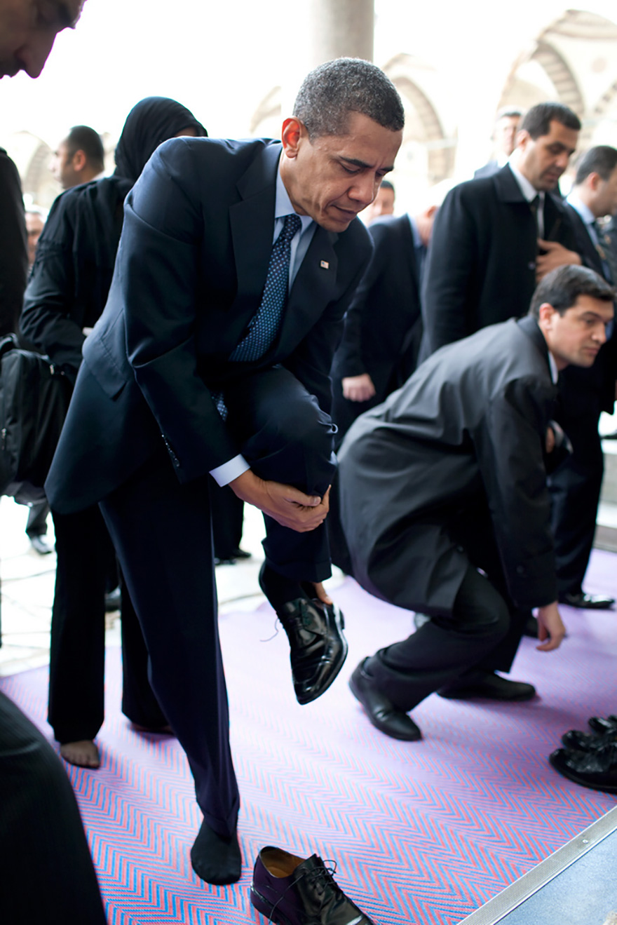 President Barack Obama Removes His Shoes As He Prepares To Visit The Blue Mosque In Istanbul, Turkey