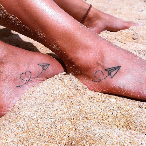 Flying paper plane ankle tattoo
