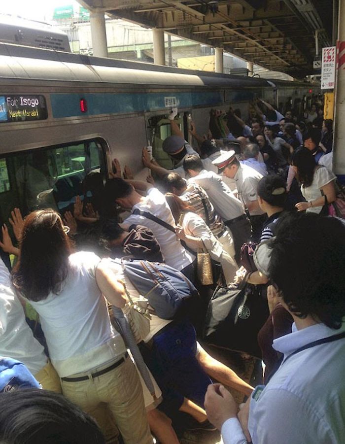 People Working Together To Help A Person Who Got Stuck Between The Platform And A Train