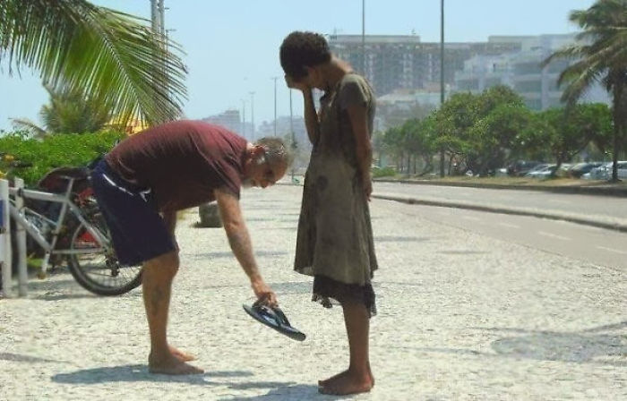 A Man Giving His Shoes To A Homeless Girl In Rio De Janeiro