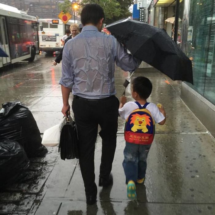 Dad Puts His Kid Under His Umbrella