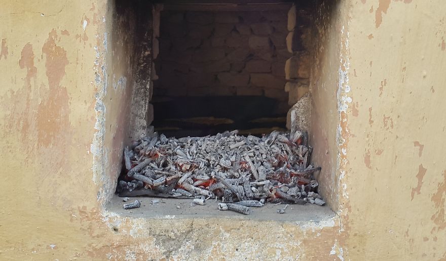 Grandmother Baking Bread In Outdoor Oven