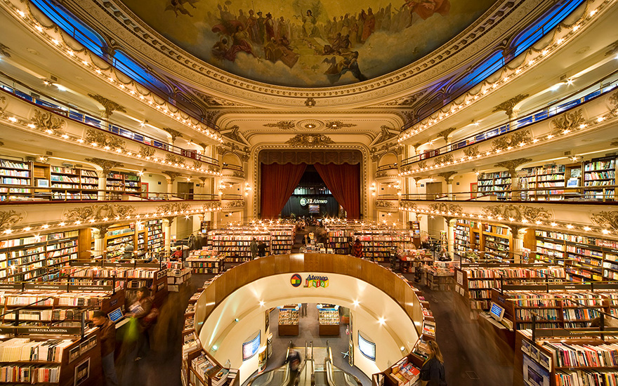 An old, round theatre room with a painted ceiling that has been turned into a beautiful book store