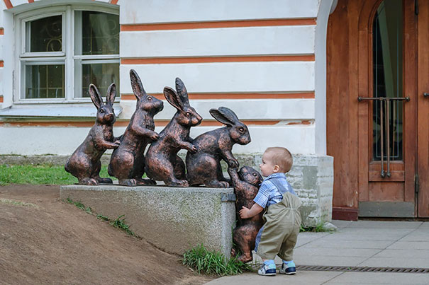 Kid Helps Bunny Climb Sculpture