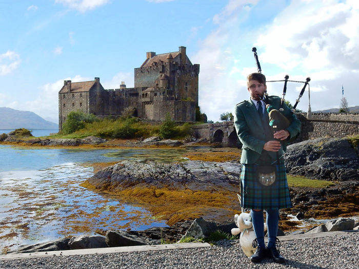 Enjoying The Bagpipes At Eilean Donan Castle In Scotland