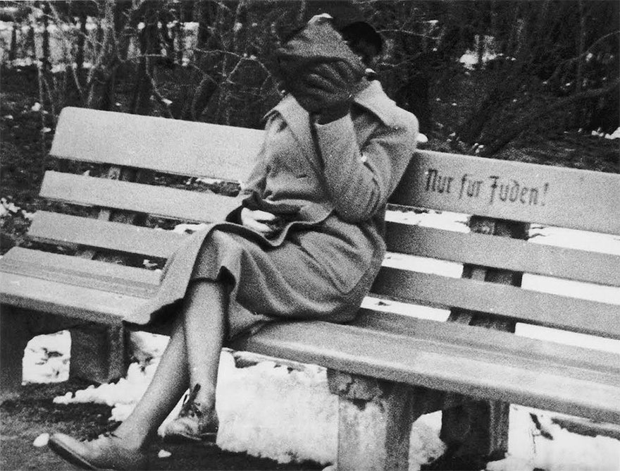 A Jewish Woman Who Is Concealing Her Face Sits On A Park Bench Marked "Only For Jews", Austria, 1938