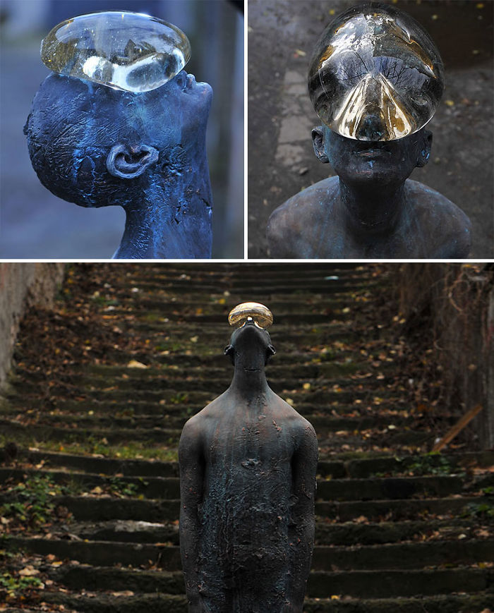 Bronze sculpture of a person with a large transparent glass-like object on their head, shown from multiple angles.