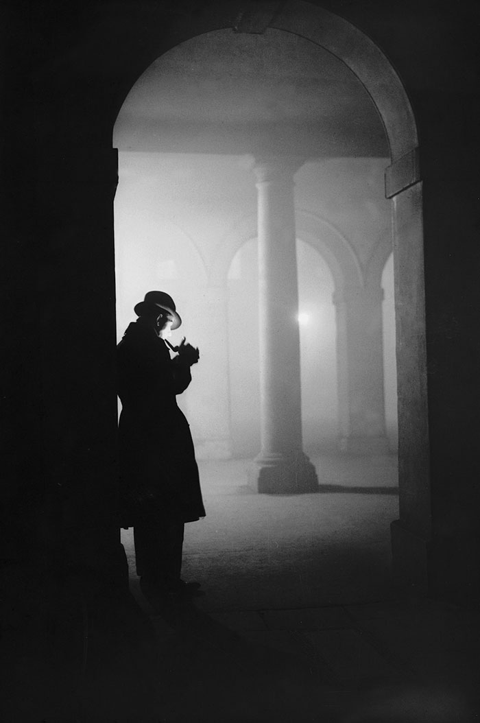 A Man Lighting His Pipe In Thick Fog Under The Arches At The Temple, London , 23 December 1935