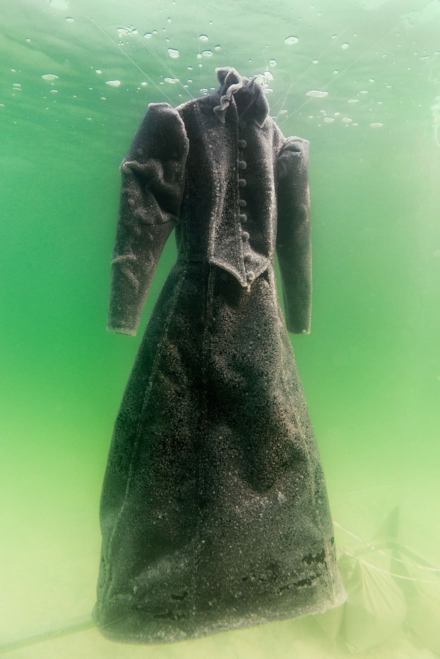The dress is placed underwater and salt crystal starts to form over the surface.