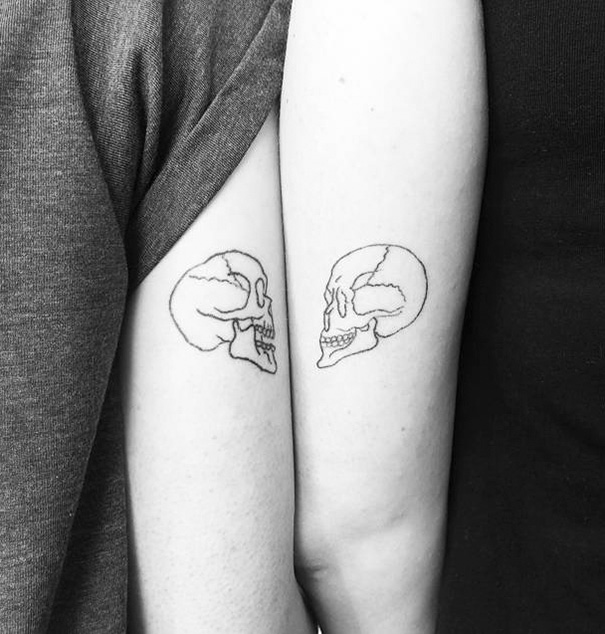 Two skull hand tattoos 