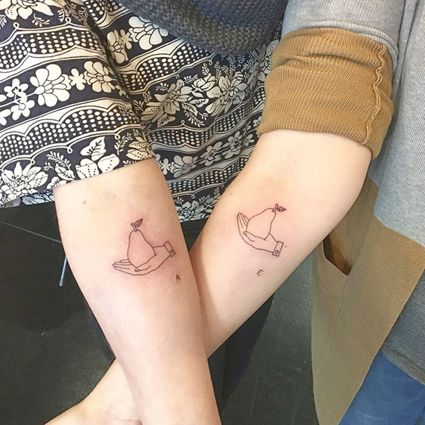 Two hand holding pear hand tattoos 