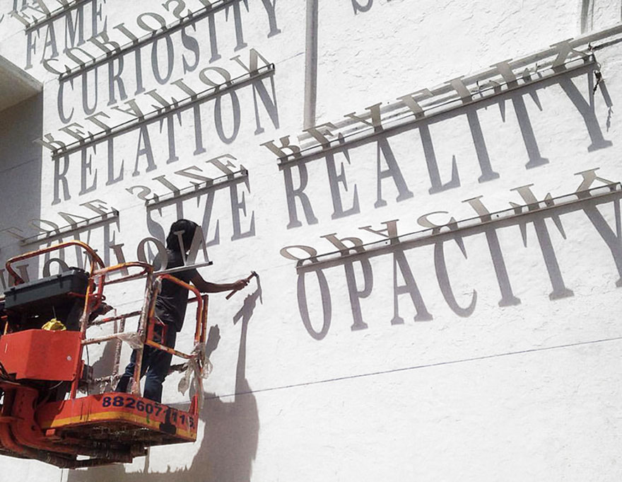 Typographic Shadow Graffiti Turns Boring Building Into Ever Changing Masterpiece