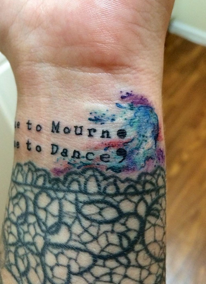 Tattoo With The Phrase “A Time To Mourn A Time To Dance” Covering A Scar From Self-Harm