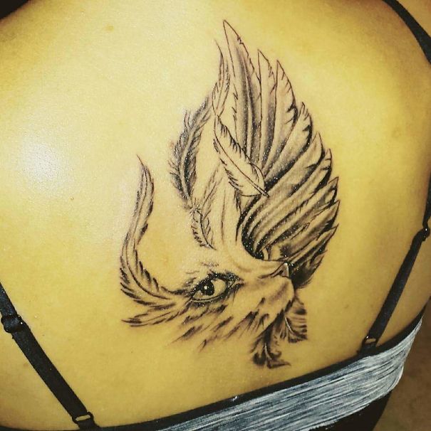 Cat with feathers back tattoo