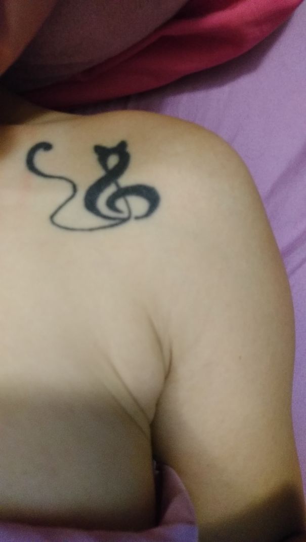 Musical cat symbol shoulder tattoo