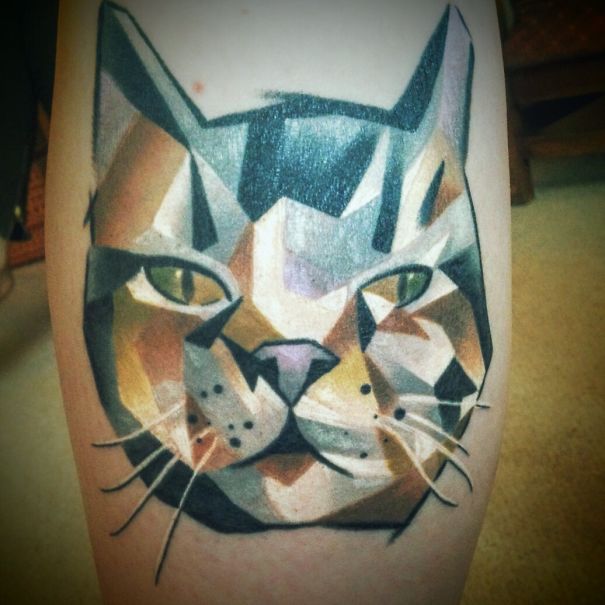 Geometrical cat face leg tattoo
