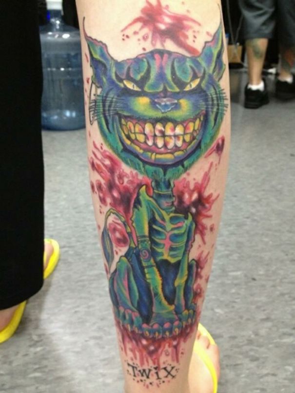 Creepy smiling colorful cat skeleton leg tattoo