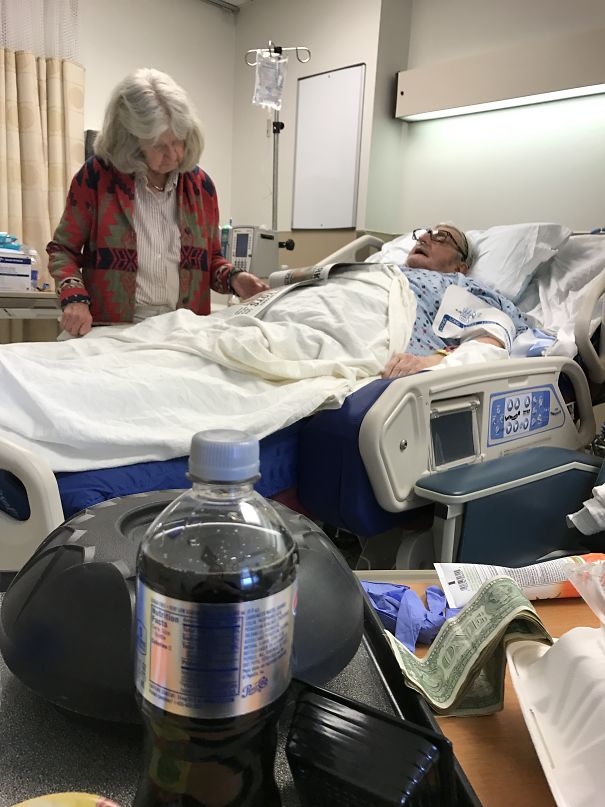 Grandma Reading Grandpa The Paper After His Surgery- She Hasn't Left The Hospital In Weeks