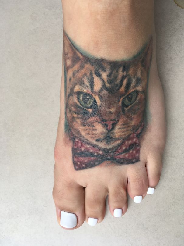 Cat face feet tattoo