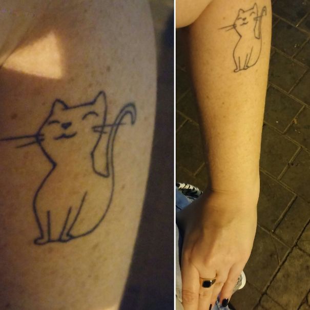 Smilling cat arm tattoo