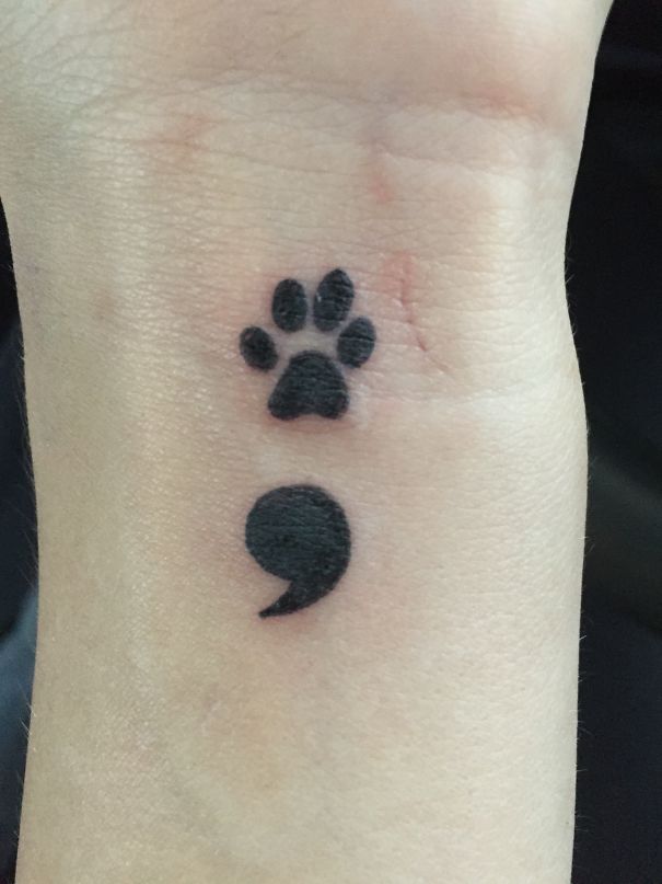 Cat symbol and paw arm tattoo