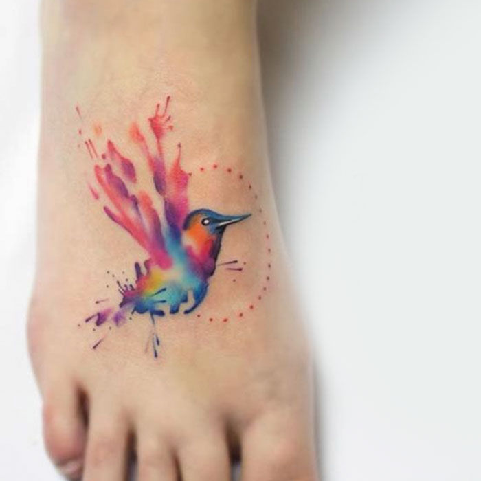 Colorful foot bird tattoo 